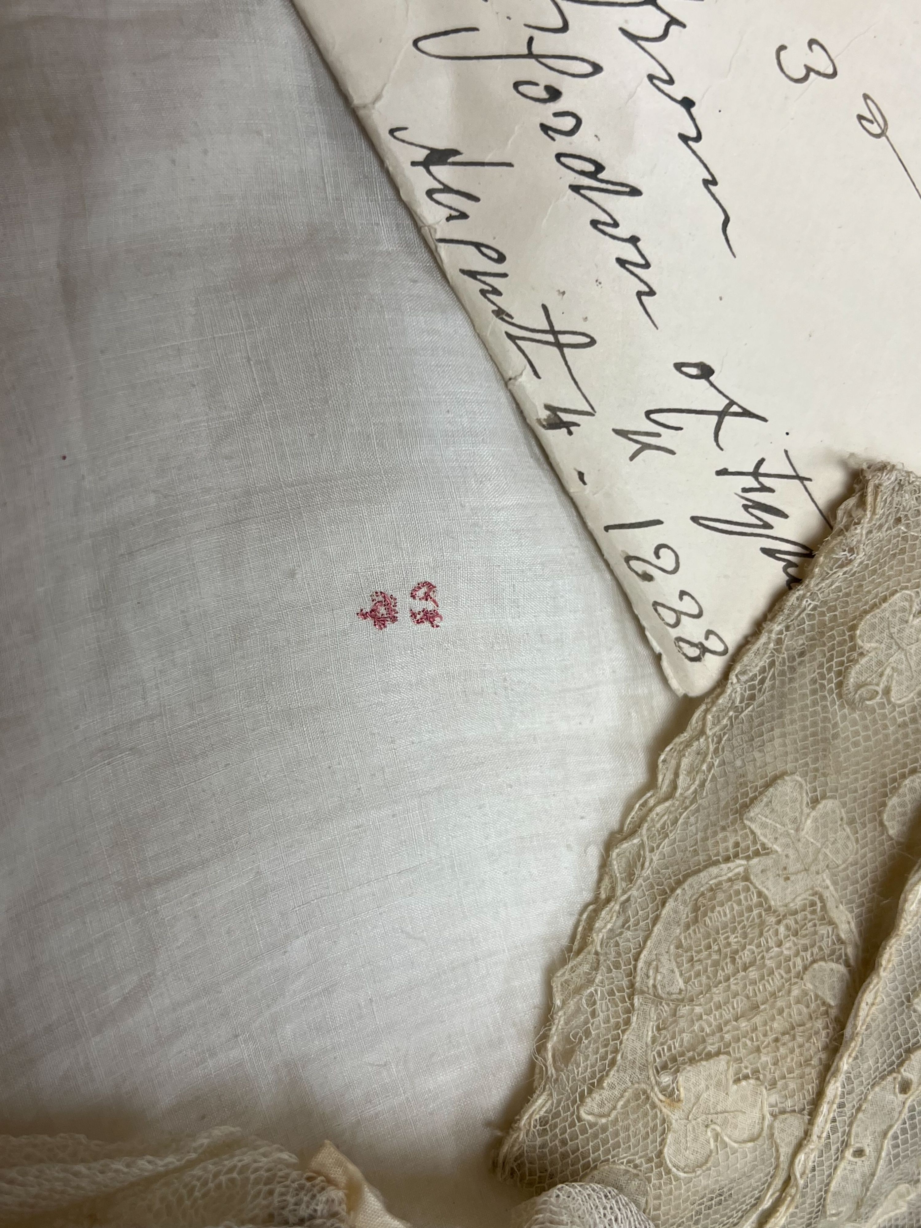 A George III handkerchief with George III cypher and three pieces of lace (4)